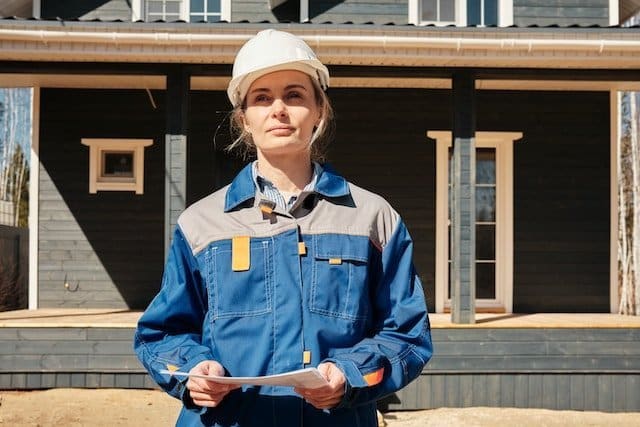 Construction Project Manager in front of home