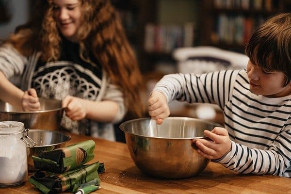 Happy kids cooking in the kitchen